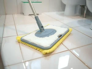 Mopping bathroom floor with flat microfiber mop, focus on gleaming tiles and residue-free surface, realistic