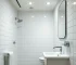 A pristine and sparkling clean bathroom, professional lighting, high detail, featuring gleaming fixtures, spotless tiles, and a clean mirror, photorealistic