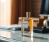 Elegant perfume bottle on a sophisticated desktop setting with warm natural lighting, photorealistic, high quality, timeless elegance