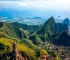 Aerial view of Bali showcasing its diverse landscapes, including lush rice terraces, dramatic ocean cliffs, serene temples, and vibrant urban life, high quality, vivid colors, natural lighting